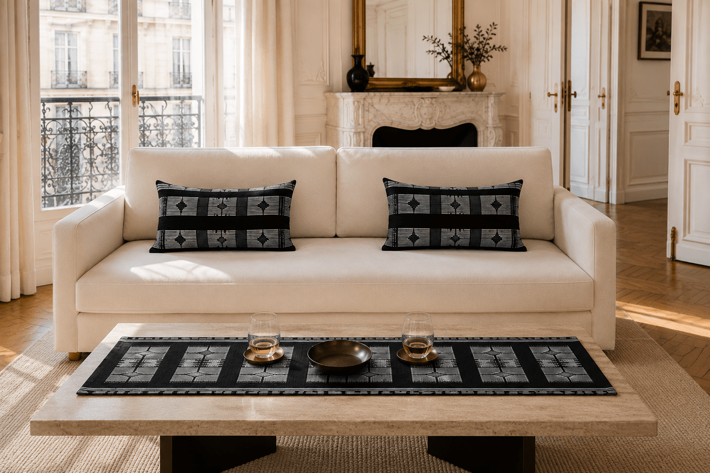 Coussins et chemin de table en pagne Manjak noir et blanc dans un intérieur parisien