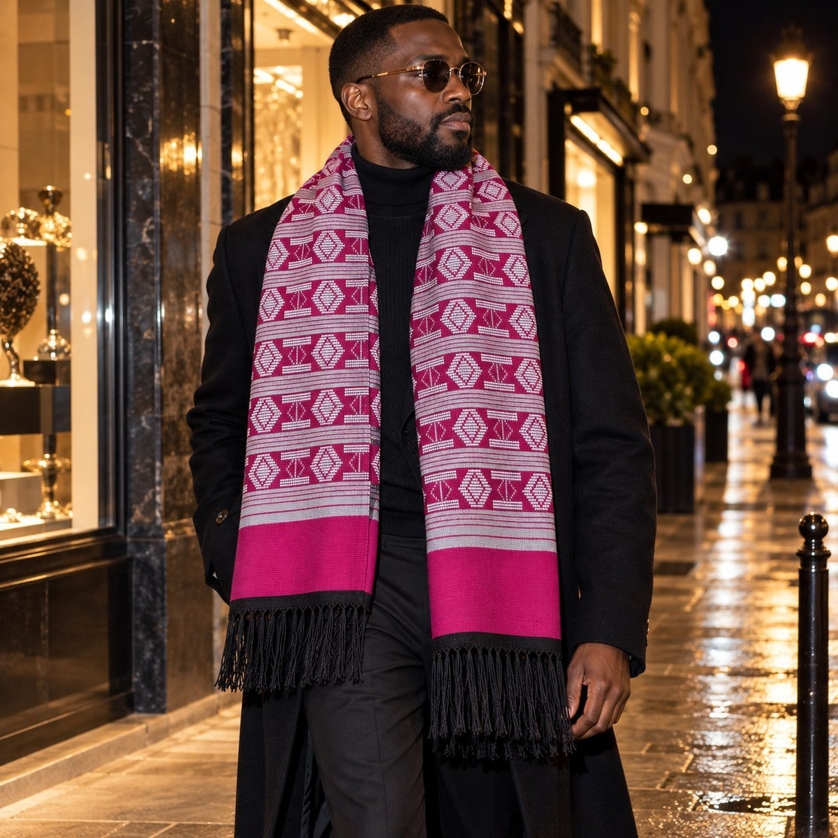 Écharpe-étole Manjak de Luxe fuchsia et blanc portée par un homme sur un manteau noir, la nuit à Paris