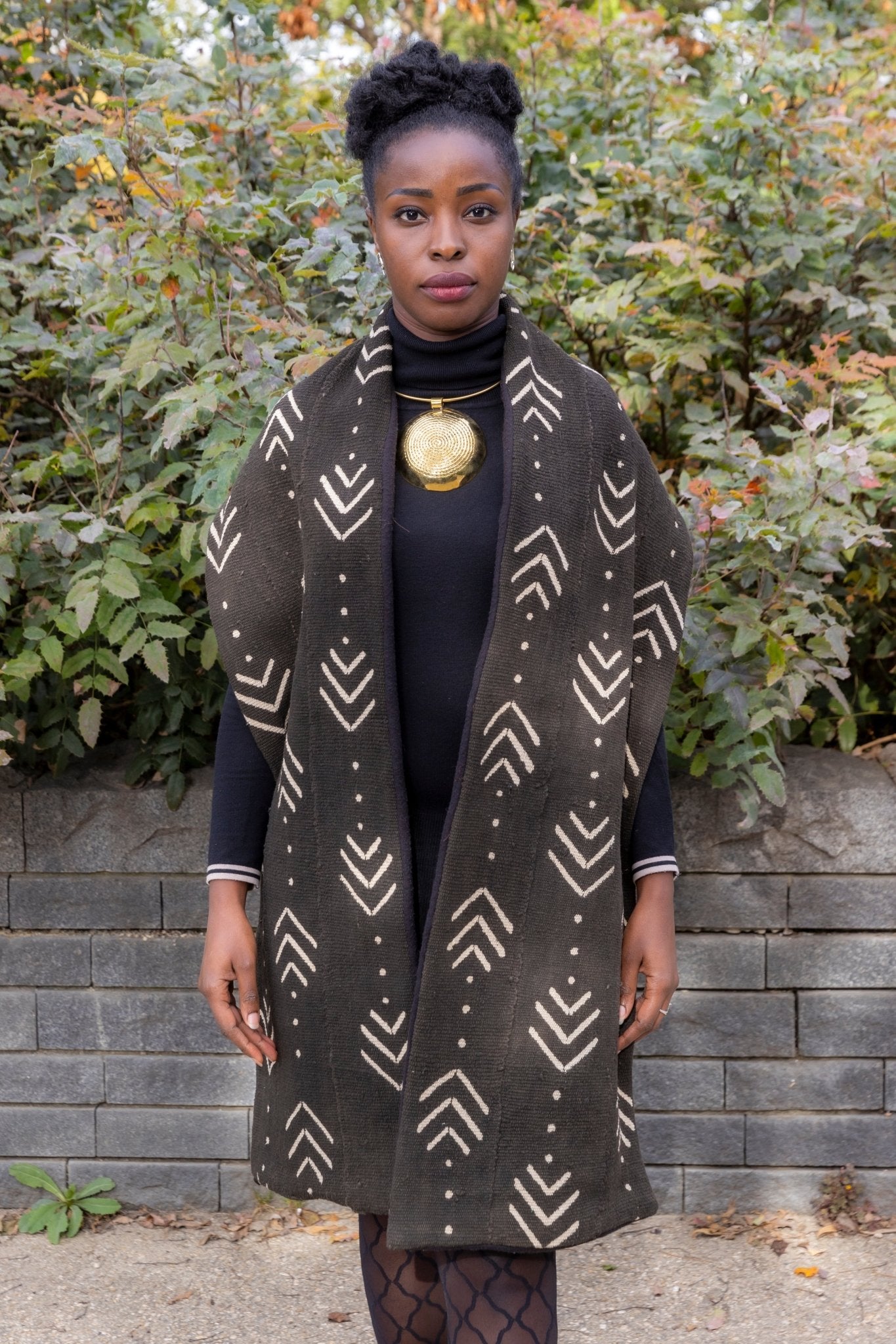 Étole en bogolan noir à motifs blancs portée par une femme